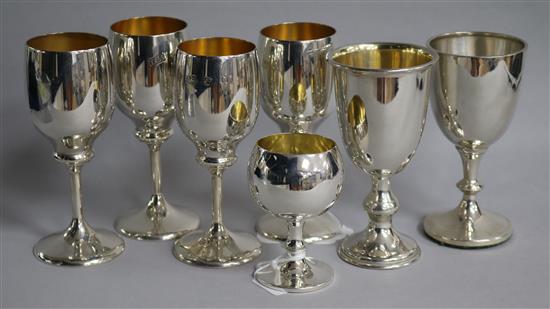 A modern set of three silver goblets, A.T. Cannon Ltd, Birmingham, 1973 and four other assorted silver goblets, gross 16 oz.